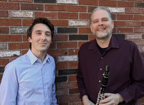 Photograph of the performers, Solon Gordon and Jonathan Russell, standing in front of a brick wall.