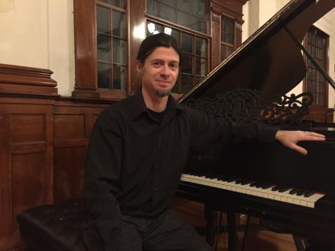 Trevor Berens, pianist Photo of Trevor Berens sitting at a piano.
